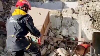 A member of the rescue team works amidst rubble in the aftermath of an earthquake in Tibet ( REUTERS)