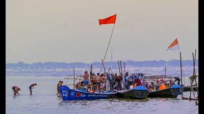 Devotees take a holy dip in Sangam, the confluence of the Ganga, Yamuna and the Saraswati rivers, on a winter morning, ahead of the ‘Maha Kumbh Mela’ festival, in Prayagraj, Wednesday (PTI)