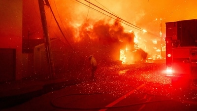 Firefighters battle the Palisades Fire in the Pacific Palisades neighborhood of Los Angeles, California. (Kyle Grillot/Bloomberg)