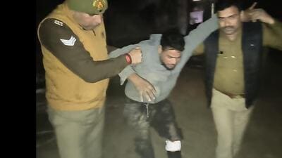 One of the suspects in police custody on Tuesday night, following a brief gunfight with police. (HT Photo) One of the suspects in police custody on Tuesday night, following a brief gunfight with police. (HT Photo)