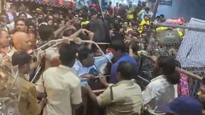 Tirupati: Police personnel try to control the crowd as hundreds of devotees jostle for tickets for Vaikunta Dwara Darshanam. (PTI) Tirupati: Police personnel try to control the crowd as hundreds of devotees jostle for tickets for Vaikunta Dwara Darshanam. (PTI)