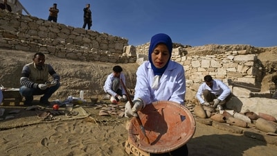 Archaeologists unearth and reassemble pieces of pottery at an intact section of the Queen Hatshepsut Valley Temple's foundations in Deir El-Bahari on the Nile's west bank in Luxor on December 8, 2025, during a media event to announce new discoveries by an Egyptian archaeological expedition. (AFP) Archaeologists unearth and reassemble pieces of pottery at an intact section of the Queen Hatshepsut Valley Temple's foundations in Deir El-Bahari on the Nile's west bank in Luxor on December 8, 2025, during a media event to announce new discoveries by an Egyptian archaeological expedition. (AFP)