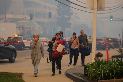 People evacuate as a wildfire breaks out near Pacific Palisades during a weather-driven windstorm on the west side of Los Angeles, California, January 7, 2025. (REUTERS)
