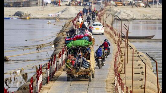 Devotees arrive at Sangam ahead of the Mahakumbh, in Prayagraj, Wednesday. (PTI Photo)