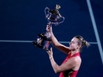 Aryna Sabalenka of Belarus holds the Daphne Akhurst Memorial Cup after defeating Zheng Qinwen of China in the 2024 women's singles final at the Australian Open