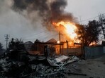 Smoke and flames rise from burning structures as powerful winds fueling devastating wildfires in the Los Angeles area force people to evacuate, at the Eaton Fire in Altadena, California, U.S. January 8, 2025.  REUTERS/Fred Greaves
