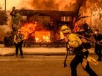 Firefighters work the scene as an apartment building burns during the Eaton fire in the Altadena area of Los Angeles county, California. (AFP) Firefighters work the scene as an apartment building burns during the Eaton fire in the Altadena area of Los Angeles county, California. (AFP)