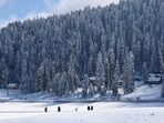 People walk through a snow-covered field in Gulmarg, a ski resort and one of the main tourist attractions in the Kashmir region, January 07, 2025. 