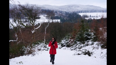 A person adjusts their scarf as they walk up towards the Hell Fire club in Dublin (Brian Lawless/PA) A person adjusts their scarf as they walk up towards the Hell Fire club in Dublin (Brian Lawless/PA)