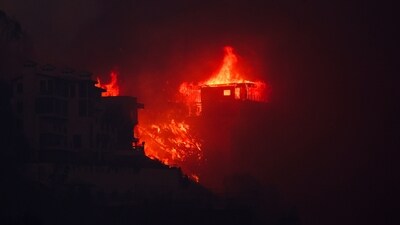 Flames rise from beachfront homes along the road to Malibu, as powerful winds fueling devastating wildfires in the Los Angeles area force people to evacuate, California. (REUTERS)