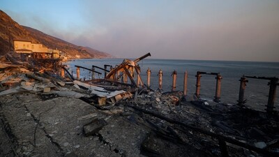 Burnt-down beachfront homes stand in ruin along the road to Malibu, as powerful winds fuel devastating wildfires in Los Angeles. Authorities are scrambling to manage the situation, with widespread evacuations and emergency declarations. (REUTERS)