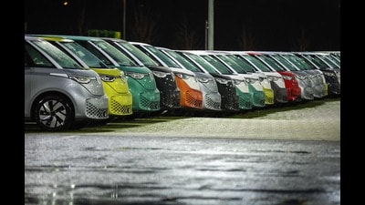 New VW ID Buzz vehicles, fully electric-driven microbus from Volkswagen Commercial Vehicles, are seen parked next to the commercial vehicle plant of German car manufacturer Volkswagen (VW) in Hanover, northern Germany, before delivery on 19 December 2024. (Photo by Ronny HARTMANN / AFP) (AFP) New VW ID Buzz vehicles, fully electric-driven microbus from Volkswagen Commercial Vehicles, are seen parked next to the commercial vehicle plant of German car manufacturer Volkswagen (VW) in Hanover, northern Germany, before delivery on 19 December 2024. (Photo by Ronny HARTMANN / AFP) (AFP)