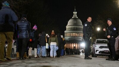 Members of the public wait outside in lines to view the flag-draped casket of former US President Jimmy Carter. (REUTERS)