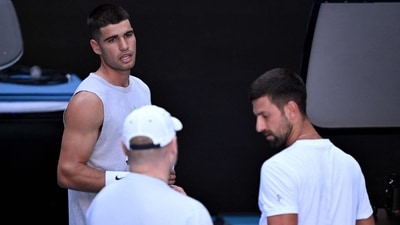 Spain's Carlos Alcaraz (L) chats with Novak Djokovic of Serbia (R) during a training session ahead of the Australian Open tennis tournament in Melbourne on January 7, 2025. (AFP) Spain's Carlos Alcaraz (L) chats with Novak Djokovic of Serbia (R) during a training session ahead of the Australian Open tennis tournament in Melbourne on January 7, 2025. (AFP)