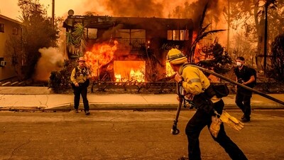 Firefighters work the scene as an apartment building burns during the Eaton fire in the Altadena area of Los Angeles county, California. (AFP) Firefighters work the scene as an apartment building burns during the Eaton fire in the Altadena area of Los Angeles county, California. (AFP)