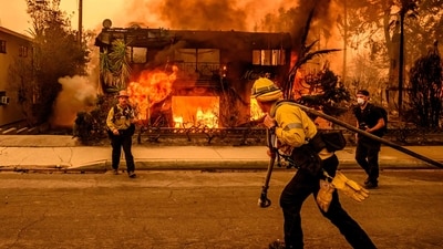Firefighters work the scene as an apartment building burns during the Eaton fire in the Altadena area of Los Angeles county, California. (AFP) Firefighters work the scene as an apartment building burns during the Eaton fire in the Altadena area of Los Angeles county, California. (AFP)