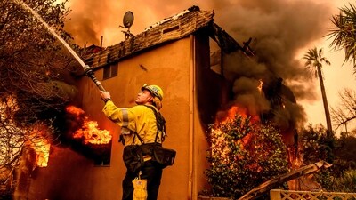 A firefighter douses flames as an apartment building burns during the Eaton fire in the Altadena area of Los Angeles county, Meanwhile, the Hurst Fire broke out and spread northeast of California's San Fernando, burning at least 500 acres. (AFP) A firefighter douses flames as an apartment building burns during the Eaton fire in the Altadena area of Los Angeles county, Meanwhile, the Hurst Fire broke out and spread northeast of California's San Fernando, burning at least 500 acres. (AFP)