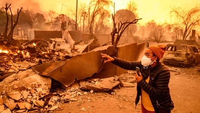 Margaret Larkin views her burned home during the Eaton fire in the Altadena area of Los Angeles County, California officials asked residents to follow evacuation orders to keep themselves and first responders out of danger as the fires continue to grow. (AFP) Margaret Larkin views her burned home during the Eaton fire in the Altadena area of Los Angeles County, California officials asked residents to follow evacuation orders to keep themselves and first responders out of danger as the fires continue to grow. (AFP)