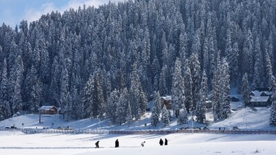 People walk through a snow-covered field in Gulmarg, a ski resort and one of the main tourist attractions in the Kashmir region, January 07, 2025. (REUTERS)