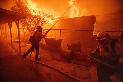 Firefighters protect a structure as the Eaton Fire advances Wednesday, January 8, 2025 in Altadena. (AP) Firefighters protect a structure as the Eaton Fire advances Wednesday, January 8, 2025 in Altadena. (AP)