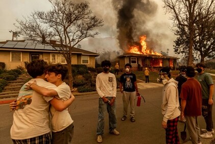 Residents embrace outside of a burning property as the Eaton Fire swept through Wednesday, Jan. 8, 2025 in Altadena. (AP) Residents embrace outside of a burning property as the Eaton Fire swept through Wednesday, Jan. 8, 2025 in Altadena. (AP)