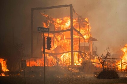 Flames from the Palisades Fire burn a building on Sunset Boulevard amid a powerful windstorm on January 8, 2025 in the Pacific Palisades neighborhood of Los Angeles, California. (AFP) Flames from the Palisades Fire burn a building on Sunset Boulevard amid a powerful windstorm on January 8, 2025 in the Pacific Palisades neighborhood of Los Angeles, California. (AFP)