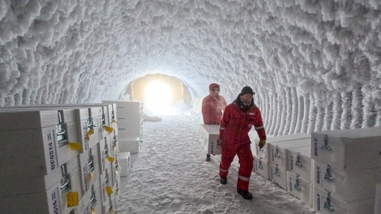 People walk through an ice core storage cave at Little Dome C field base on Tuesday, Jan. 7, 2025, in in eastern Antarctica. (PNRA/IPEV Beyond Epica via AP) (AP)