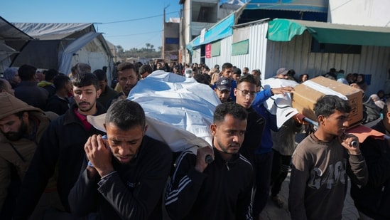 Palestinians carry the bodies of their relatives killed in the Israeli bombardment in Deir al-Balah, Gaza, (AP/Abdel Kareem Hana)
