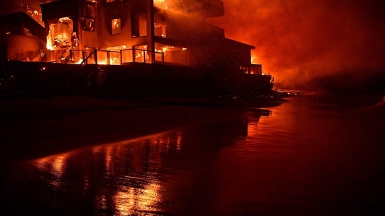 A beach house is engulfed in flames as the Palisades Fire burns along Pacific Coast Highway in Malibu, California. (AFP)
