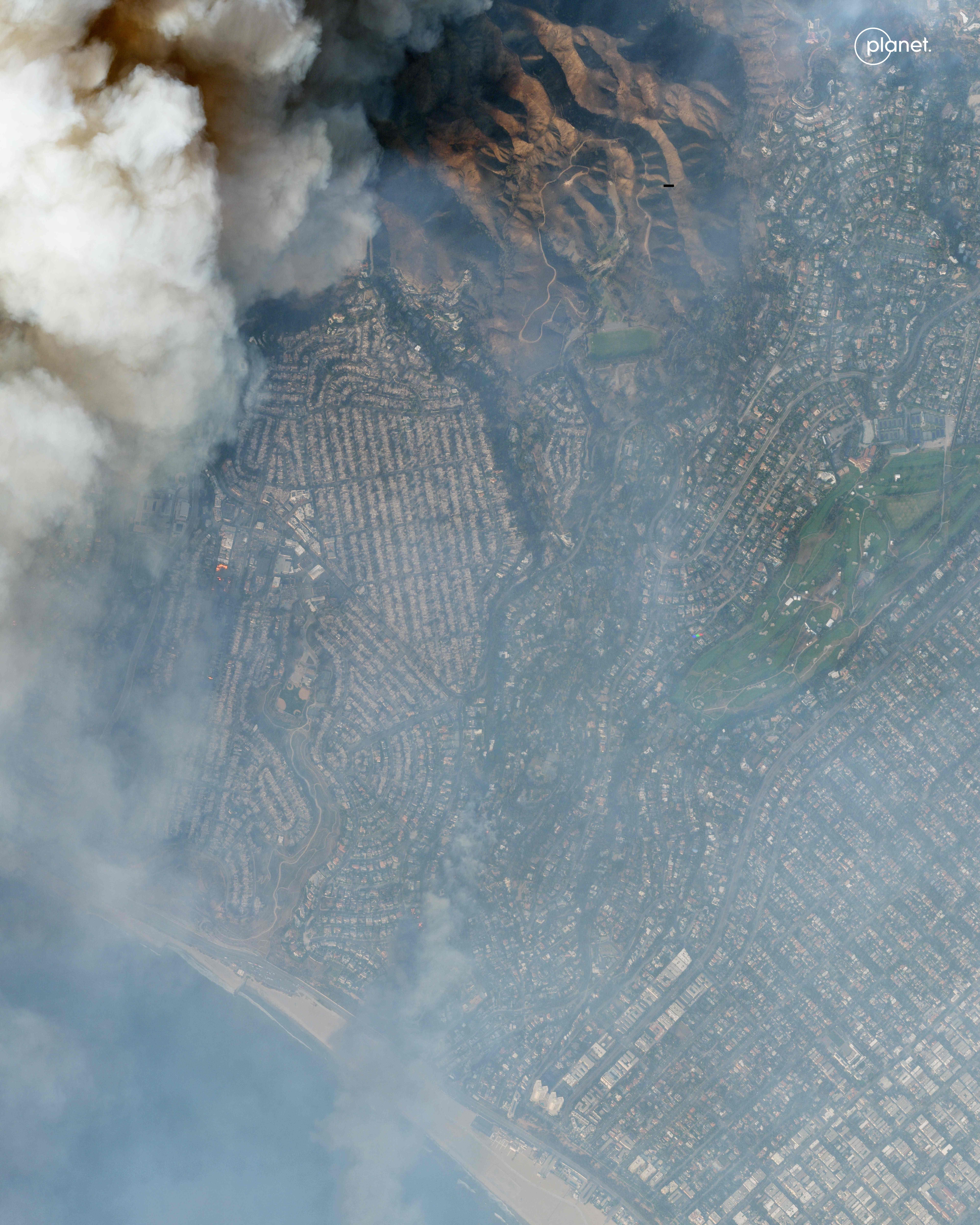This handout satellite image taken and released by Planet Labs PBC on January 8, 2025 shows smoke from the Palisades Fire near Pacific Palisades, California. At least five people have been killed in wildfires rampaging around Los Angeles, officials said on January 8, with firefighters overwhelmed by the speed and ferocity of multiple blazes -- including in Hollywood. (Photo by Planet Labs PBC / AFP) / XGTY / RESTRICTED TO EDITORIAL USE - MANDATORY CREDIT "AFP PHOTO / PLANET LABS PBC" - NO MARKETING - NO ADVERTISING CAMPAIGNS - DISTRIBUTED AS A SERVICE TO CLIENTS - EXISTING WATERMARKS MAY NOT BE REMOVED/CROPPED (AFP)