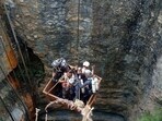 Divers use a pulley to enter a coal mine to rescue trapped miners in Umrangso, a remote area in the northeastern state of Assam (REUTERS)