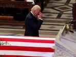 U.S. President  Joe Biden gestures next to a casket during a service, on the day of the State Funeral for former U.S. President Jimmy Carter, at the Washington National Cathedral in Washington, U.S., January 9, 2025. 