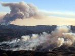 The Kenneth fire (below) approaches homes while the back side of the Palisade fire (above) continues to burn Los Angeles county, California on January 9, 2025. 