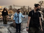 People look through the charred ruins of their home burned in the Eaton Fire in Altadena, California, January 9, 2025. Massive wildfires that engulfed whole neighborhoods and displaced thousands in Los Angeles remained totally uncontained January 9, 2025, 