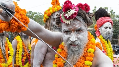 A saint of Shri Panchayati Mahanirvani Akhara displays a sword during a religious procession on the first Royal Entry 'Chavni Pravesh' for the Maha Kumbh Mela 2025, in Prayagraj. (ANI)
