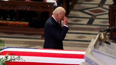 U.S. President  Joe Biden gestures next to a casket during a service, on the day of the State Funeral for former U.S. President Jimmy Carter, at the Washington National Cathedral in Washington, U.S., January 9, 2025. (REUTERS/Brendan Mcdermid )