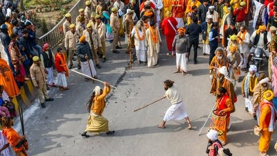 Sadhus partake in a stick fight in the 'Chavni Pravesh' procession on their way to the Maha Kumbh.  (PTI)