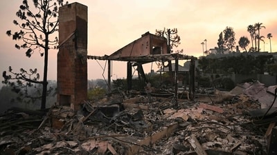 A man stands amid the rubble of his parents' home, destroyed during the Palisades Fire, in Pacific Palisades, a neighborhood of Los Angeles, California, on January 9, 2025. The two largest fires burning in Los Angeles remain "zero percent" contained on January 9 despite firefighting operations, officials said, as they also vowed to tackle looting of evacuated homes. (Patrick T Fallon/AFP) A man stands amid the rubble of his parents' home, destroyed during the Palisades Fire, in Pacific Palisades, a neighborhood of Los Angeles, California, on January 9, 2025. The two largest fires burning in Los Angeles remain "zero percent" contained on January 9 despite firefighting operations, officials said, as they also vowed to tackle looting of evacuated homes. (Patrick T Fallon/AFP)