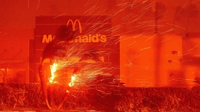 A McDonald's restaurant is showered in embers during the Eaton fire in Pasadena, California. A ferocious wildfire in a Los Angeles suburb devoured buildings and sparked panicked evacuations January 7, as hurricane-force winds tore through the region. (Josh Edelson/AFP) A McDonald's restaurant is showered in embers during the Eaton fire in Pasadena, California. A ferocious wildfire in a Los Angeles suburb devoured buildings and sparked panicked evacuations January 7, as hurricane-force winds tore through the region. (Josh Edelson/AFP)