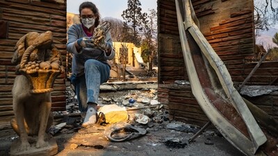 A woman sorts through the ruins of her family home destroyed by the Eaton Fire in Altadena, California. Officials reported that the Eaton Fire damaged or destroyed 4,000–5,000 structures, while the Palisades Fire caused destruction to another 5,300. (AFP) A woman sorts through the ruins of her family home destroyed by the Eaton Fire in Altadena, California. Officials reported that the Eaton Fire damaged or destroyed 4,000–5,000 structures, while the Palisades Fire caused destruction to another 5,300. (AFP)
