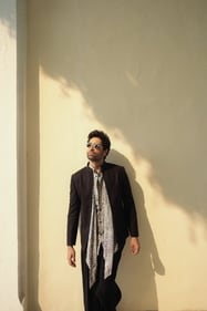 Redefining 70s retro vibe, Adivi Sesh rocks in a leopard print shirt with a bow detail paired with a bandhgala and pants from Shantnu & Nikhil. He rounds off the look with a pair of circular sunglasses from The Tinted Story. Redefining 70s retro vibe, Adivi Sesh rocks in a leopard print shirt with a bow detail paired with a bandhgala and pants from Shantnu & Nikhil. He rounds off the look with a pair of circular sunglasses from The Tinted Story.