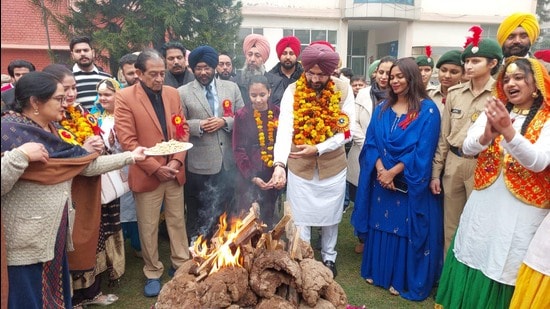 Cabinet Minister Tarunpreet Singh Sand, along with others, celebrating ‘Dhiyan di Lohri' at AS College in Khanna, Ludhiana, on Friday. (HT Photo)