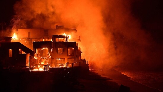 A beach house is engulfed in flames as the Palisades Fire burns along Pacific Coast Highway in Malibu, California, on January 8, 2025.&nbsp;(AFPAgustin Paullier/AFP)