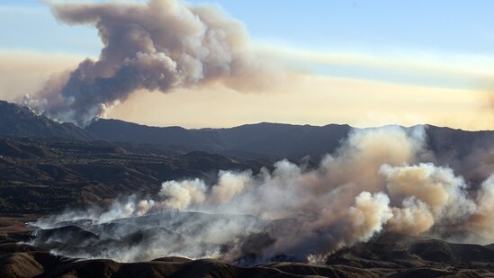 In this aerial view taken from a helicopter, the Kenneth fire (below) approaches homes while the back side of the Palisade fire (above) continues to burn Los Angeles county, California on January 9, 2025.&nbsp;(Josh Edelson/AFP)