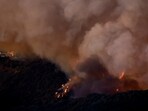 Smoke and fire billows from the Palisades Fire threatening homes in the Brentwood area of Los Angeles, California, U.S., January 11, 2025.  REUTERS/Shannon Stapleton