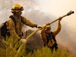 Firefighters work towards stopping the spread of six fires currently raging in Los Angeles Firefighters work towards stopping the spread of six fires currently raging in Los Angeles
