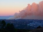 Smoke billows from the Palisades fire as seen from Saddle Peak Road, near Fernwood, Topanga, a community in western Los Angeles County, California in January 10, 2024. Smoke billows from the Palisades fire as seen from Saddle Peak Road, near Fernwood, Topanga, a community in western Los Angeles County, California in January 10, 2024.