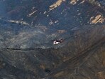 Massive wildfires that engulfed whole neighborhoods and displaced thousands in Los Angeles have killed at least 10 people, authorities said, as California's National Guard soldiers readied to hit the streets to help quell disorder.