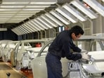 FILE PHOTO: An employee works on the assembly line at the Volkswagen automobile manufacturing factory in Puebla, Mexico, August 12, 2010. REUTERS/Imelda Medina/File Photo