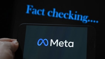 This photo illustration created on January 8, 2025, in Brussels, shows the media giant Meta's logo displayed on a smartphone and screen displaying the words "fact checking". (Photo by Nicolas TUCAT / AFP) (AFP) This photo illustration created on January 8, 2025, in Brussels, shows the media giant Meta's logo displayed on a smartphone and screen displaying the words "fact checking". (Photo by Nicolas TUCAT / AFP) (AFP)